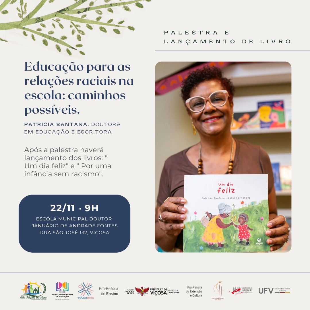 Mulher de meia-idade negra, cabelos curtos crespos e óculos de armação grossa sorri, segurando um livro. 